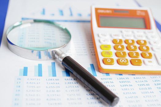 Magnifying glass on charts graphs paper. Financial development, Banking Account, Statistics, Investment Analytic research data economy.