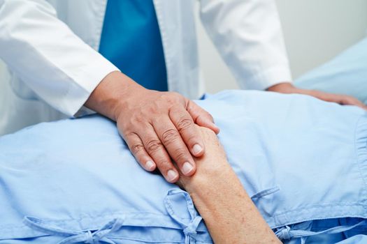 Doctor holding hands Asian elderly woman patient, help and care in hospital.