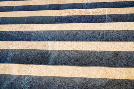 Staircase in the city, black and white pattern on the stairs on a sunny day