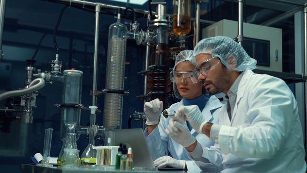 Two scientist in professional uniform working in laboratory for chemical and biomedical experiment