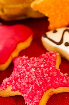 Assorted christmas cookies on red background.