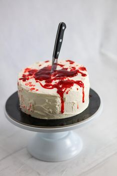 Bleeding monster cake with knife on cake stand