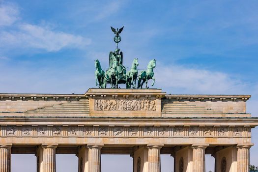 The horse team of the Quadriga on the Brandenburg Gate in Berlin against blue sky