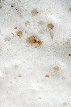 Beer foam top view. Soft fresh Foam on light beer. Bubble froth of beer. Beer foam texture background.