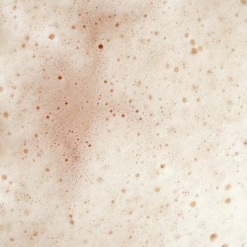 Beer foam top view. Soft fresh Foam on light beer. Bubble froth of beer. Beer foam texture background.