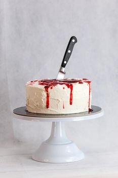 Bleeding monster cake with knife on cake stand