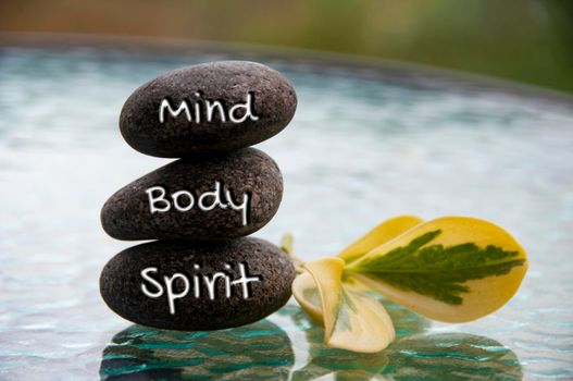 Mind, Body and Soul words engraved on zen stones with space for text. Copy space and zen concept.