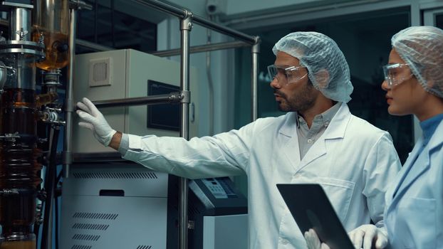Two scientist in professional uniform working in laboratory for chemical and biomedical experiment