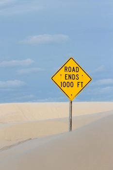 Yellow road sign at the end of the road.