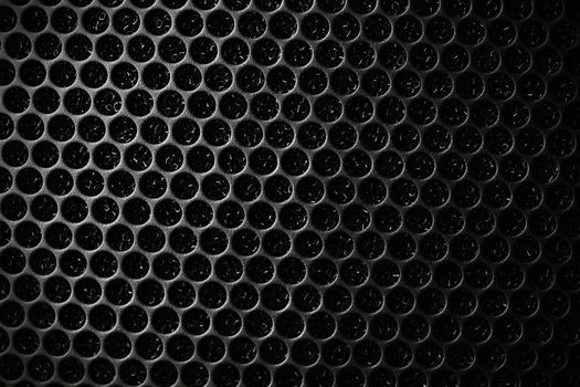 Safety net on the music speaker. Protective grid audio speakers. Close view of Black safety net. Metal perforated mesh, abstract pattern, Abstract black background. Professional audio equipment.
