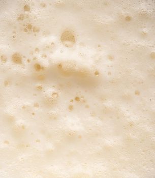 Beer foam top view. Soft fresh Foam on light beer. Bubble froth of beer. Beer foam texture background.