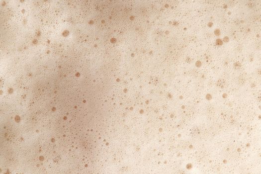 Beer foam top view. Soft fresh Foam on light beer. Bubble froth of beer. Beer foam texture background.