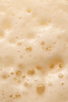 Beer foam top view. Soft fresh Foam on light beer. Bubble froth of beer. Beer foam texture background.