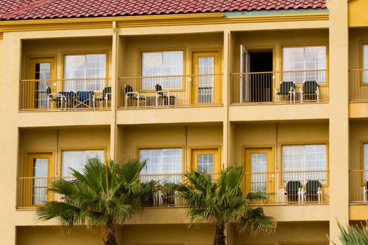Yellow hotel with balconies.
