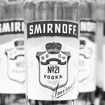 Russian vodka. Bottles of Smirnoff vodka on a shelf in duty free shop in Dubai Airport. Traditional Russian souvenir. 12,02,2022, Dubai, UAE.