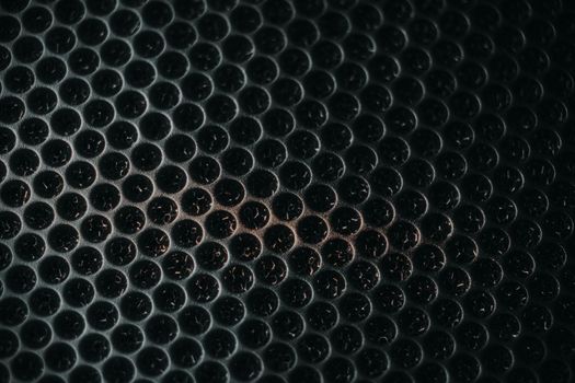 Safety net on the music speaker. Protective grid audio speakers. Close view of Black safety net. Metal perforated mesh, abstract pattern, Abstract black background. Professional audio equipment.