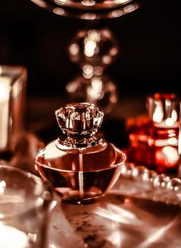 Perfumery, cosmetics branding and luxe concept - Perfume bottle and vintage fragrance on glamour vanity table at night, pearls jewellery and eau de parfum as holiday gift, luxury beauty brand present