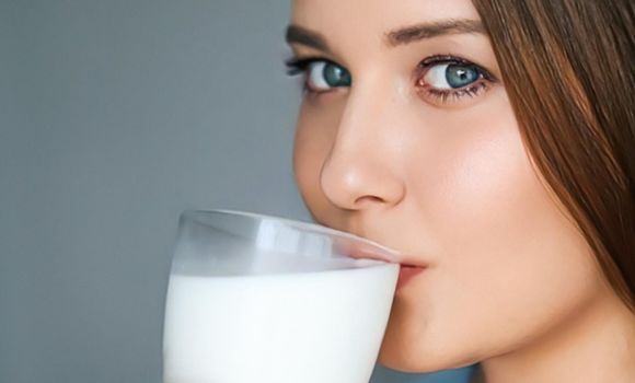 Diet and wellness, young woman drinking milk or protein shake cocktail, portrait