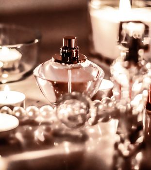 Perfumery, cosmetics branding and luxe concept - Perfume bottle and vintage fragrance on glamour vanity table at night, pearls jewellery and eau de parfum as holiday gift, luxury beauty brand present