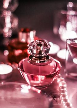 Perfumery, cosmetics branding and luxe concept - Perfume bottle and vintage fragrance on glamour vanity table at night, pearls jewellery and eau de parfum as holiday gift, luxury beauty brand present