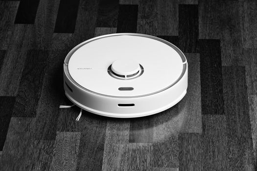 Smart Robot Vacuum Cleaner Xiaomi roborock s5 max on wood floor. Robot vacuum cleaner performs automatic cleaning of the apartment. 04.12.2020, Rostov region, Russia.