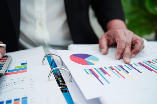 Business woman working and analysis with statistic graph in office.