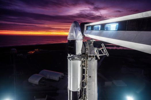 View of the SpaceX Falcon 9 rocket with a spaceship Crew Dragon on the launch pad, before launching into space. SpaceX Crew. Elements of this image furnished by NASA.
