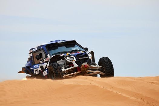 Women's crew at the rally. Sports car gets over the difficult part of the route during the Rally raid THE GOLD OF KAGAN-2021. 26.04.2021 Astrakhan, Russia.