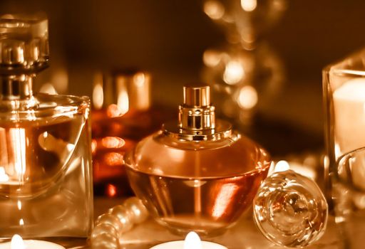 Perfumery, cosmetics branding and luxe concept - Perfume bottle and vintage fragrance on glamour vanity table at night, pearls jewellery and eau de parfum as holiday gift, luxury beauty brand present