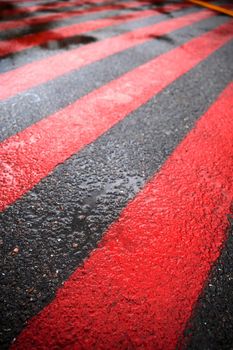 Road marking for fire tracks parking. abstract background of red and white markings for fire fighting equipment on wet pavement.