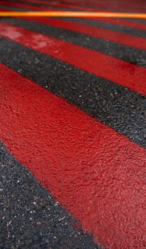 Road marking for fire tracks parking. abstract background of red and white markings for fire fighting equipment on wet pavement.