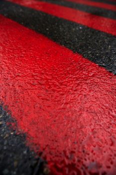 Road marking for fire tracks parking. abstract background of red and white markings for fire fighting equipment on wet pavement.