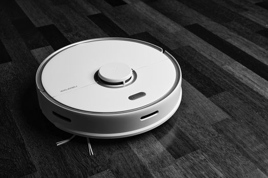 Smart Robot Vacuum Cleaner Xiaomi roborock s5 max on wood floor. Robot vacuum cleaner performs automatic cleaning of the apartment. 04.12.2020, Rostov region, Russia.