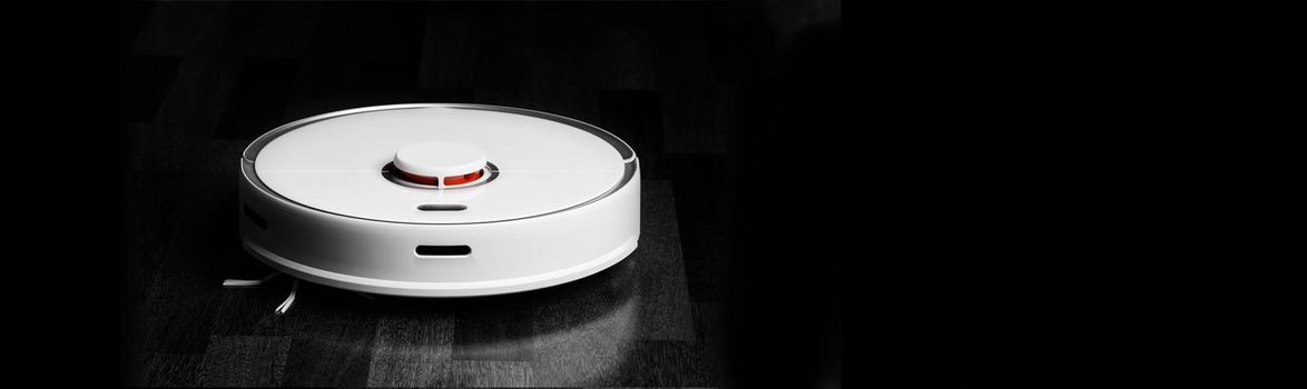 Smart Robot Vacuum Cleaner. Robot vacuum cleaner performs automatic cleaning of the apartment at a certain time. Smart home.
