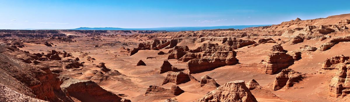 Herman Cav Canyon at sunset. South Gobi, Mongolia. Herman Tsav Canyon. Red Sandstone plateau, Martian landscape. The site of many paleontological finds. Cemetery of dinosaurs.