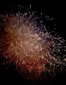 Colorful fireworks of various colors over night sky, Real Fireworks on Deep Black Background Sky on Fireworks festival show before independence day on 4 of July. Beautiful fireworks show.