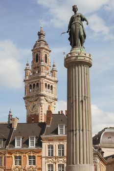 Historic facades at the Grand Place in the city of Lille, the goddess column, and the belfry of the Chambre de Commerce in background.