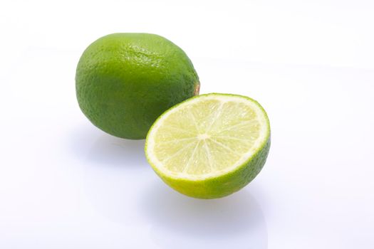 Fresh, natural, green limes cut in half isolated on a white background.