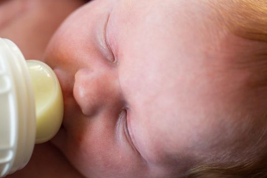 Newborn baby girl at feeding time.