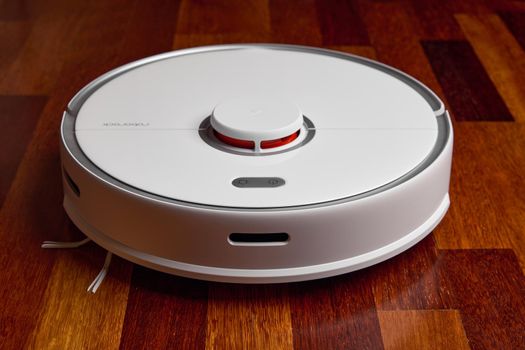 Smart Robot Vacuum Cleaner Xiaomi roborock s5 max on wood floor. Robot vacuum cleaner performs automatic cleaning of the apartment. 04.12.2020, Rostov region, Russia.