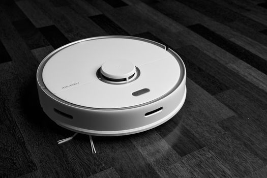 Smart Robot Vacuum Cleaner Xiaomi roborock s5 max on wood floor. Robot vacuum cleaner performs automatic cleaning of the apartment. 04.12.2020, Rostov region, Russia.