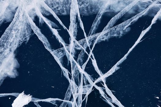 Texture of ice of Baikal lake in Siberia. blue lake ice.