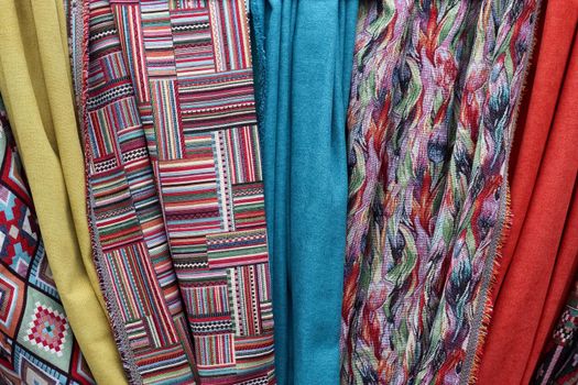 Detailed close up view on samples of cloth and fabrics in different colors found at a fabrics market.