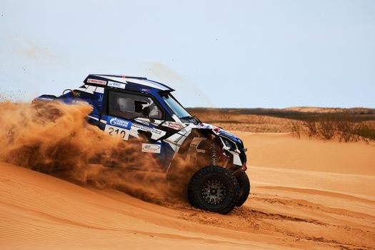 Women's crew at the rally. Sports car gets over the difficult part of the route during the Rally raid THE GOLD OF KAGAN-2021. 26.04.2021 Astrakhan, Russia.