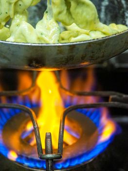 chef blending green ricotta cheese spinach filling tortellini