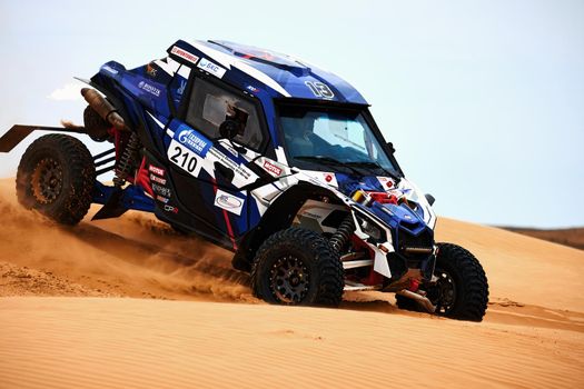 Women's crew at the rally. Sports car gets over the difficult part of the route during the Rally raid THE GOLD OF KAGAN-2021. 26.04.2021 Astrakhan, Russia.