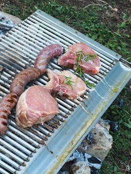 cooking pork meat in the grill outdoors with charcoal
