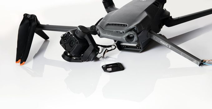 Drone DJI Mavic 3 after crashed on a white background. Drone after falling from a height. Broken gimbal camera and drone motor arm after crash. 08.05,2022. Rostov region, Russia.