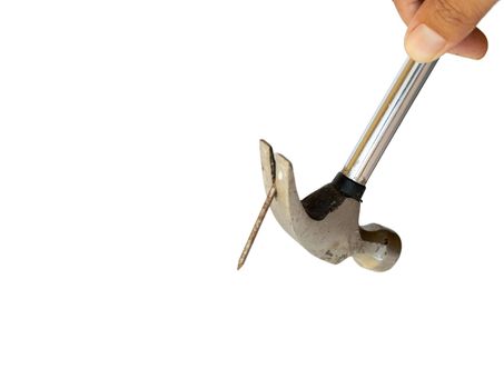 Holding hammer in hand pulling nail on white isolated background