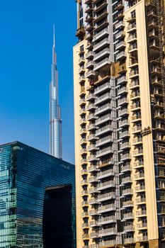 Dubai, UAE - 09.29.2022 - Modern buildings in Business Bay district. Opus tower, Burj Khalifa